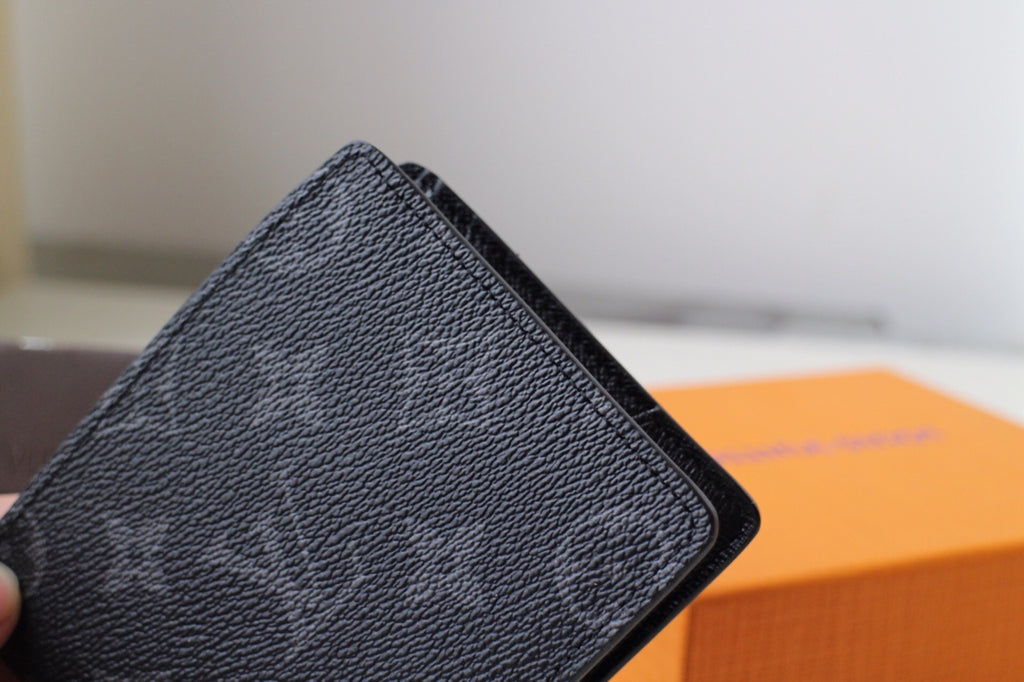 Louis Vuitton small bag, close-up of black textured leather edge and trim