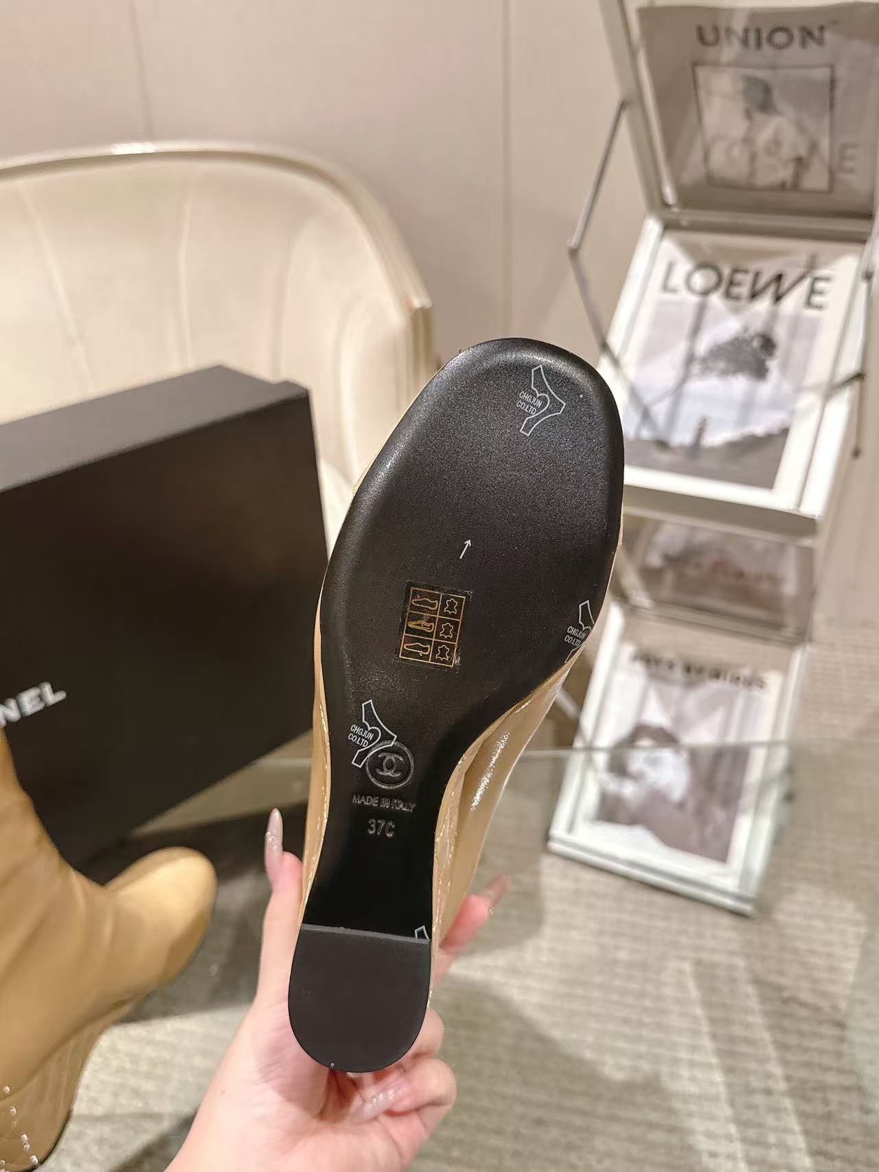 Chanel black patent leather boot sole, underside view with brand markings