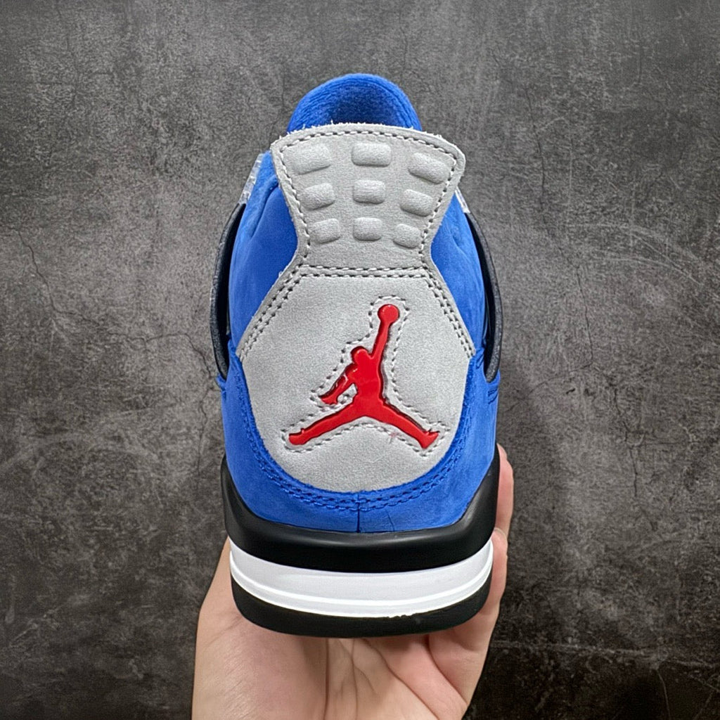 Air Jordan 4 sneakers heel view in blue suede with gray panel, red Jumpman logo, white sole