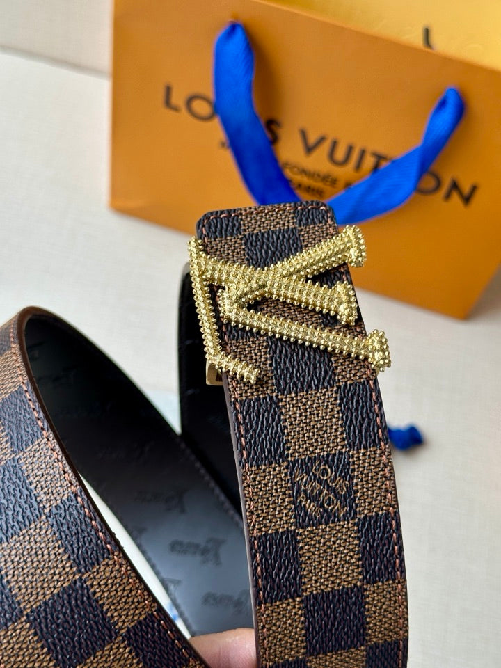 Louis Vuitton belt buckle detail with gold hardware on Damier check strap