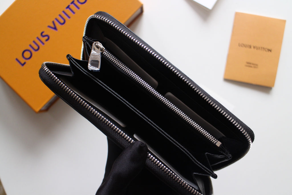Dark textured leather zip wallet open view showing interior slots and zipper