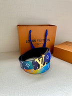 Blue monogram belt with wide strap and gold-tone buckle on display