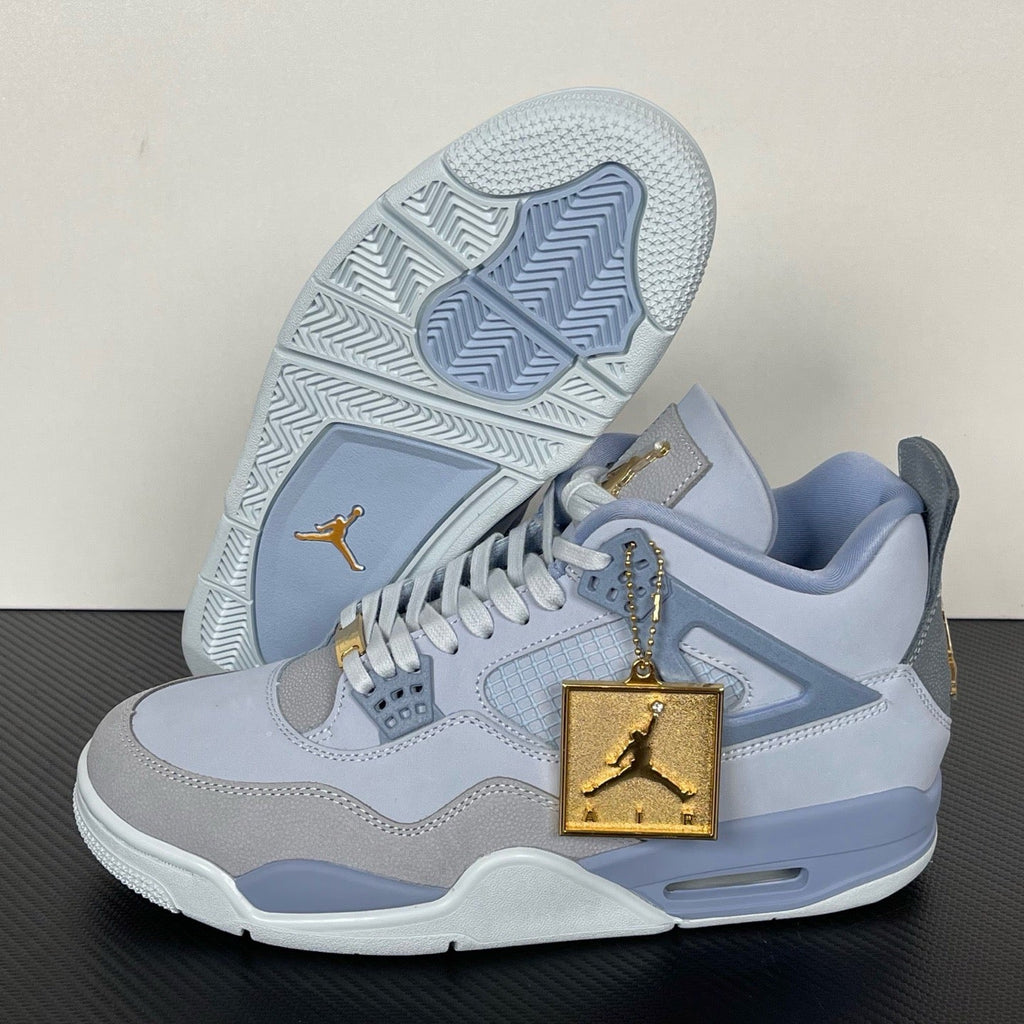 Light blue and gray Air Jordan 4 sneakers with gold Jumpman lace tag