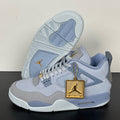 Light blue and gray Air Jordan 4 sneakers with gold Jumpman lace tag