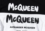 Pullover hoodie graphic close-up: McQueen lettering and Alexander McQueen text.
