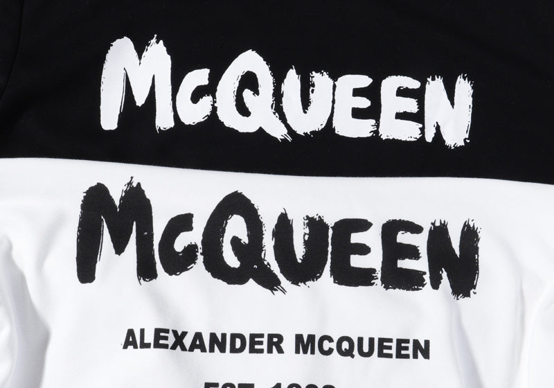 Pullover hoodie graphic close-up: McQueen lettering and Alexander McQueen text.