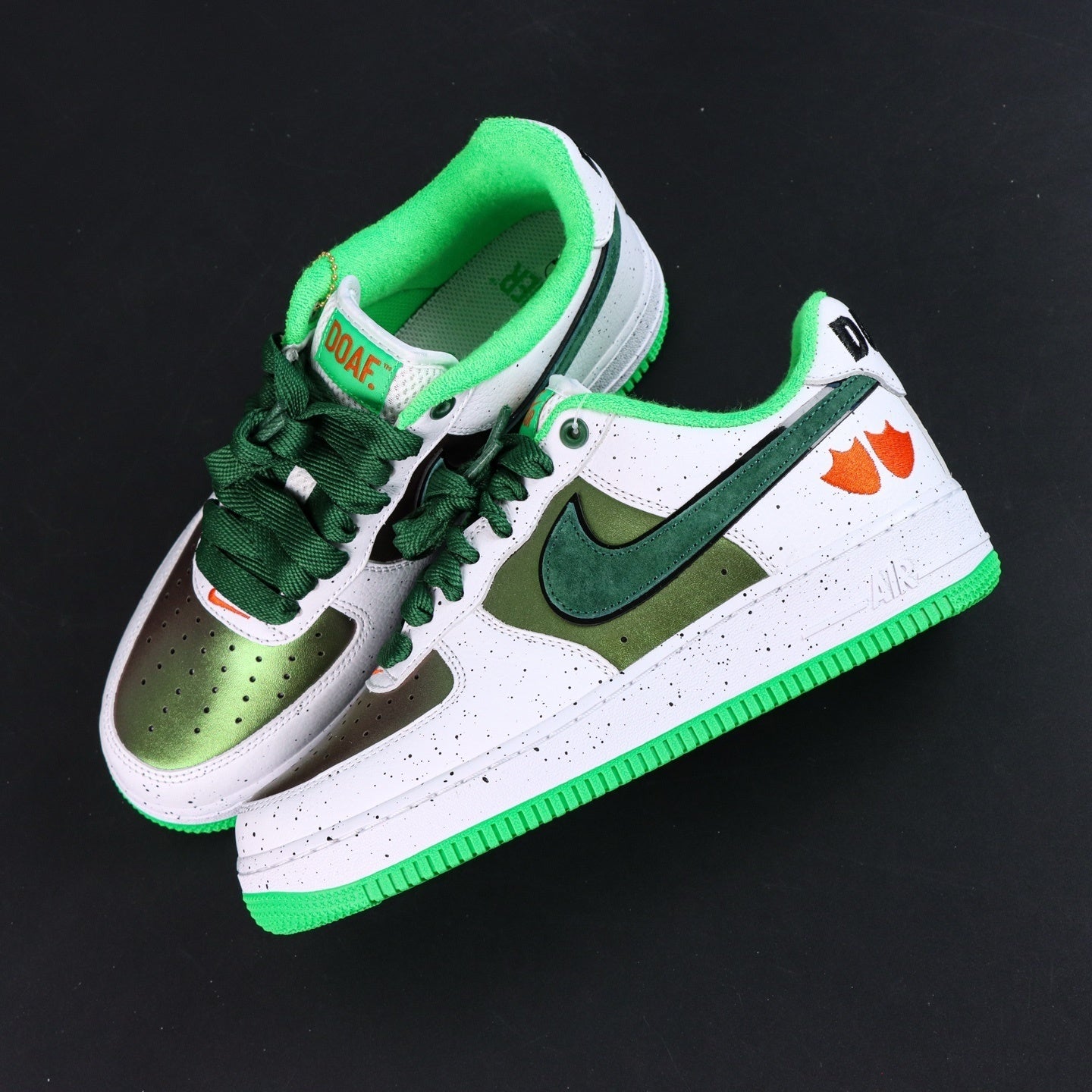 Air Force 1 sneakers, white and olive panels with green swoosh; orange duck detail.
