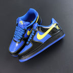Nike Air Force 1 low-top sneakers, blue and black with yellow Swoosh; angled side view.