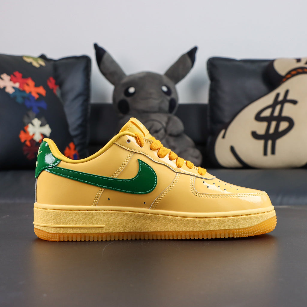 Nike Air Force 1 sneakers, yellow with green swoosh, lace-up side view