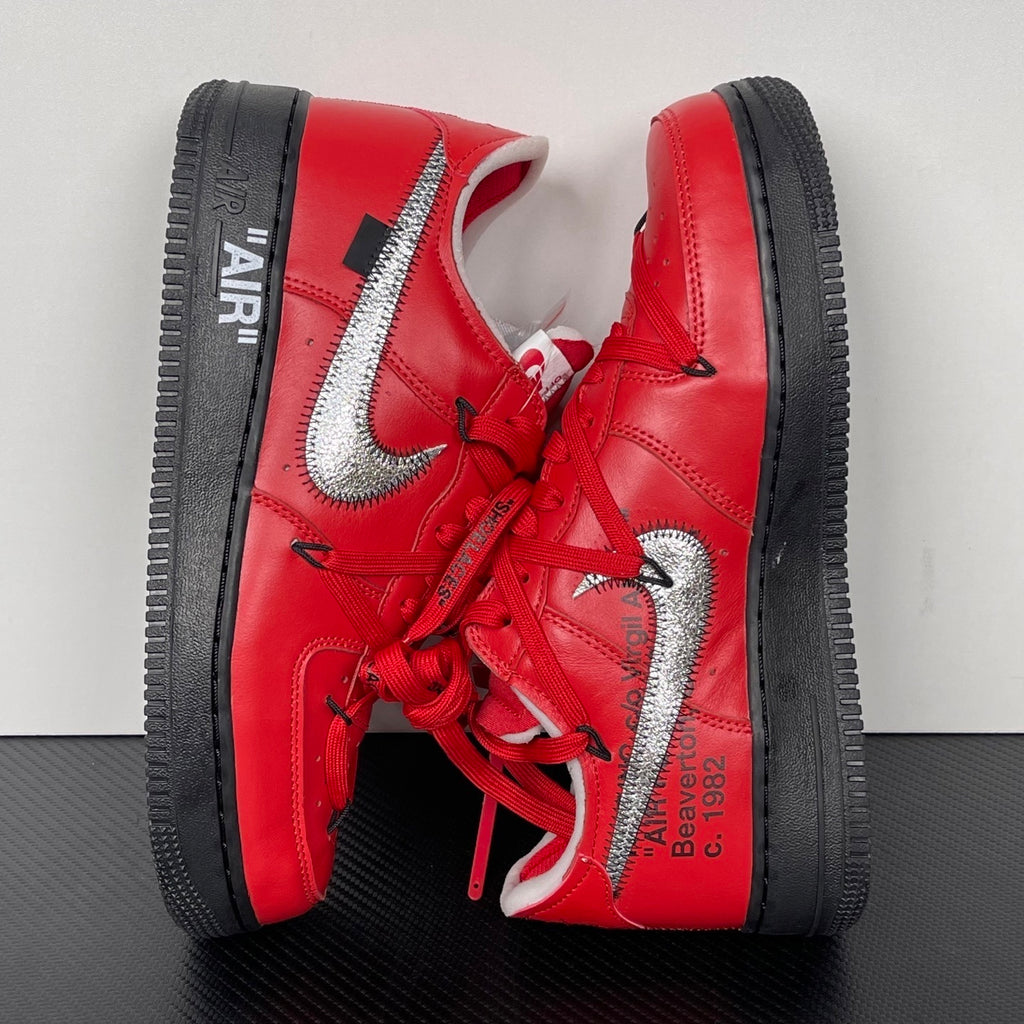 Red sneakers with black outsole, silver swoosh and heel branding detail