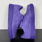 Pair of purple low-top sneakers shown from the side with lace-up closure