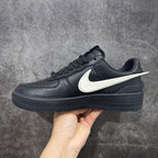 Black leather low-top sneakers with white Nike swoosh and lace-up upper