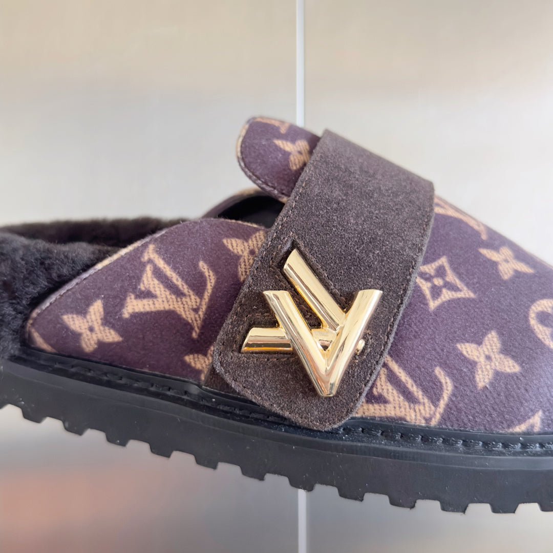 Louis Vuitton monogram sandals close-up: dark strap with gold V buckle and textured rubber sole