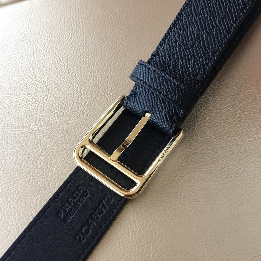 Dark leather belt close-up of gold buckle and prong