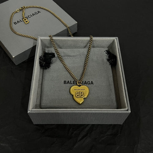 Heart pendant necklace with gold chain and heart charm in a gift box.
