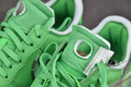 Green sneaker tongue and lace area with white collar and black logo patch