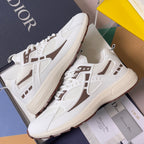 Dior unisex sneakers on box, white with brown logo stripe and lace-up upper detail