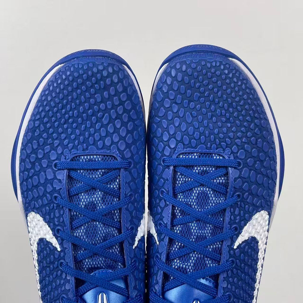 Blue Nike basketball sneaker toe view with blue laces and white side panels