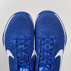 Blue Nike basketball sneaker toe view with blue laces and white side panels