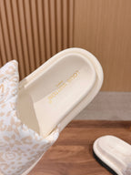 Louis Vuitton slide sandal heel view with gold logo on white footbed