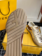 Fendi sneaker outsole: thick rubber tread, metallic silver upper with brown trim.