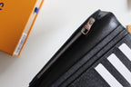 Small Louis Vuitton black textured cardholder with metal zipper pull, top view