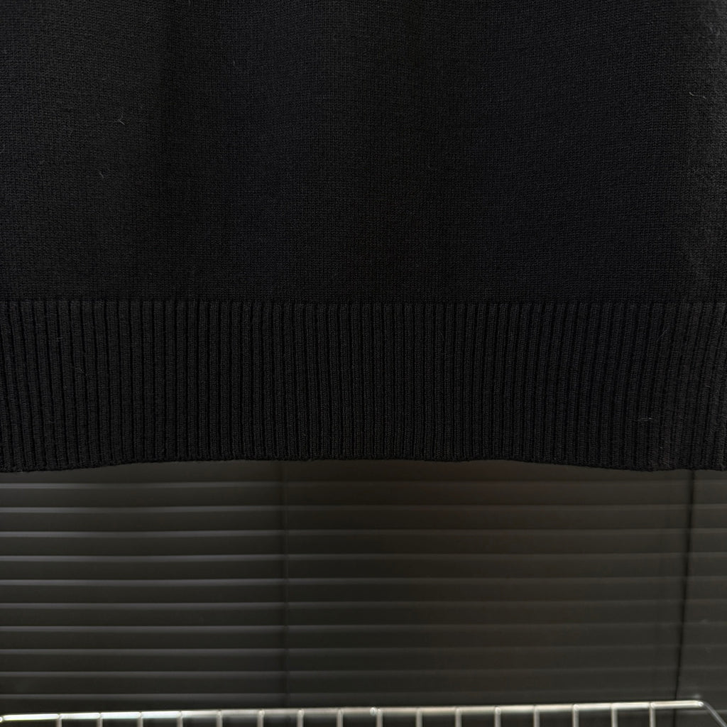 Black Moncler sweater ribbed hem band and knit texture close-up