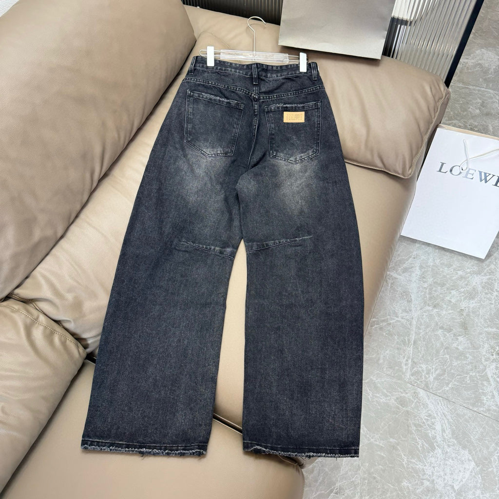 Maison Margiela dark wash denim jeans with straight-wide fit and distressed finish
