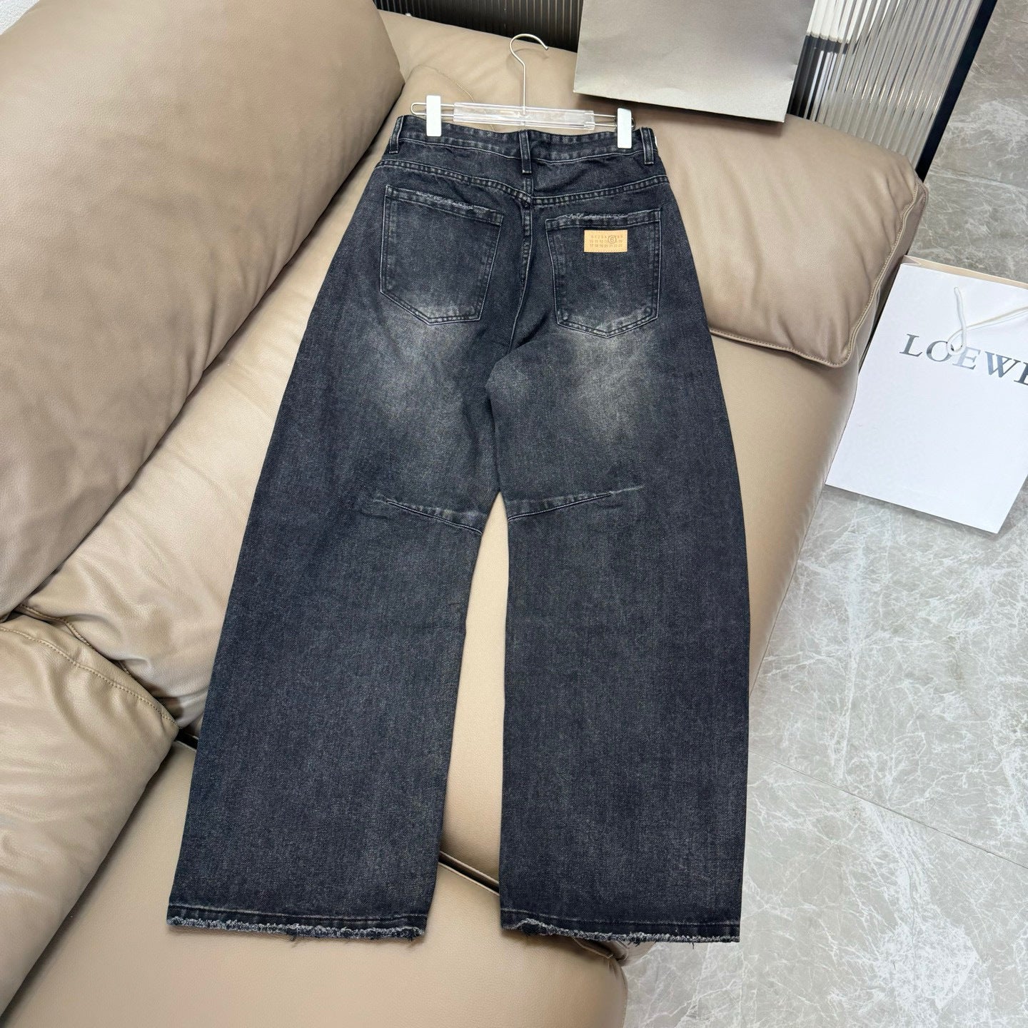Maison Margiela dark wash denim jeans with straight-wide fit and distressed finish