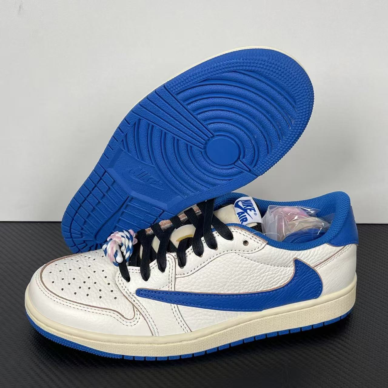 White and blue low-top sneakers showing outsole and lace decoration