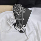 White long-sleeve raglan T-shirt with black clothing label and hanging tag