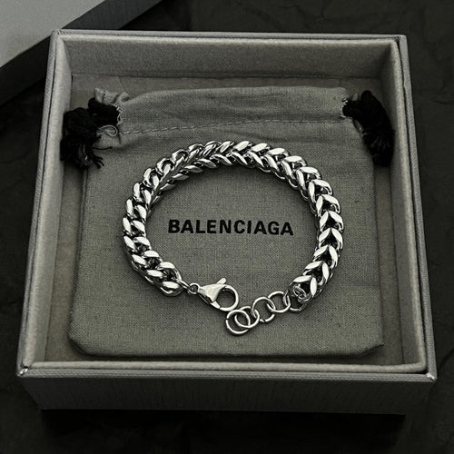 Silver chain bracelet with BALENCIAGA logo engraving and black tassel accents in box