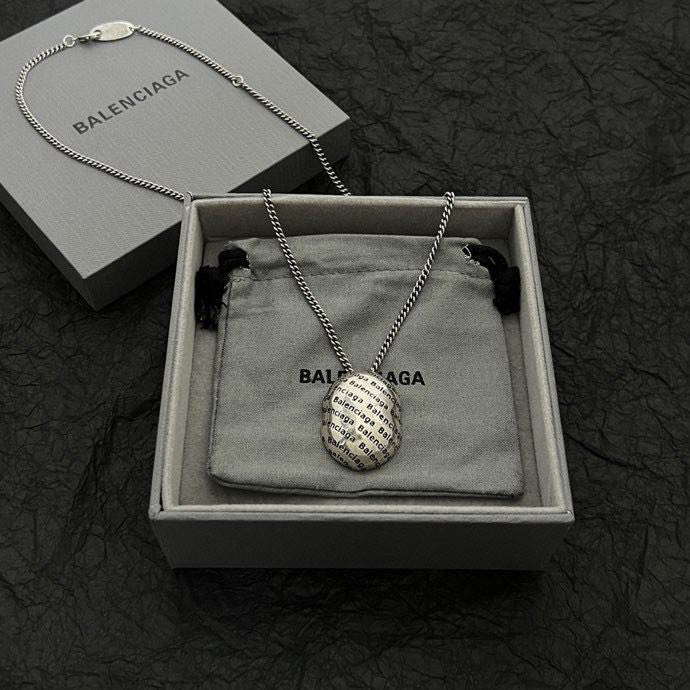 Silver-tone chain necklace with round logo pendant, shown in gift box