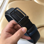 Navy belt with arched buckle and textured strap, shown end view.