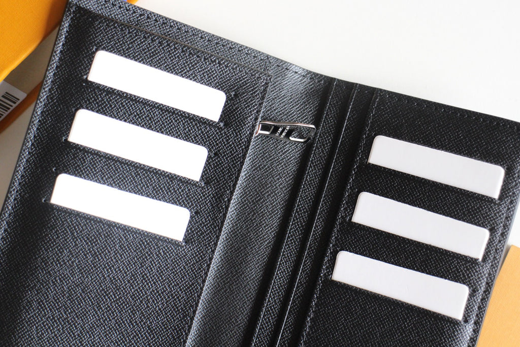 Small Louis Vuitton black cardholder close-up, white card slots and center divider