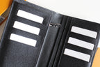 Small Louis Vuitton black cardholder close-up, white card slots and center divider