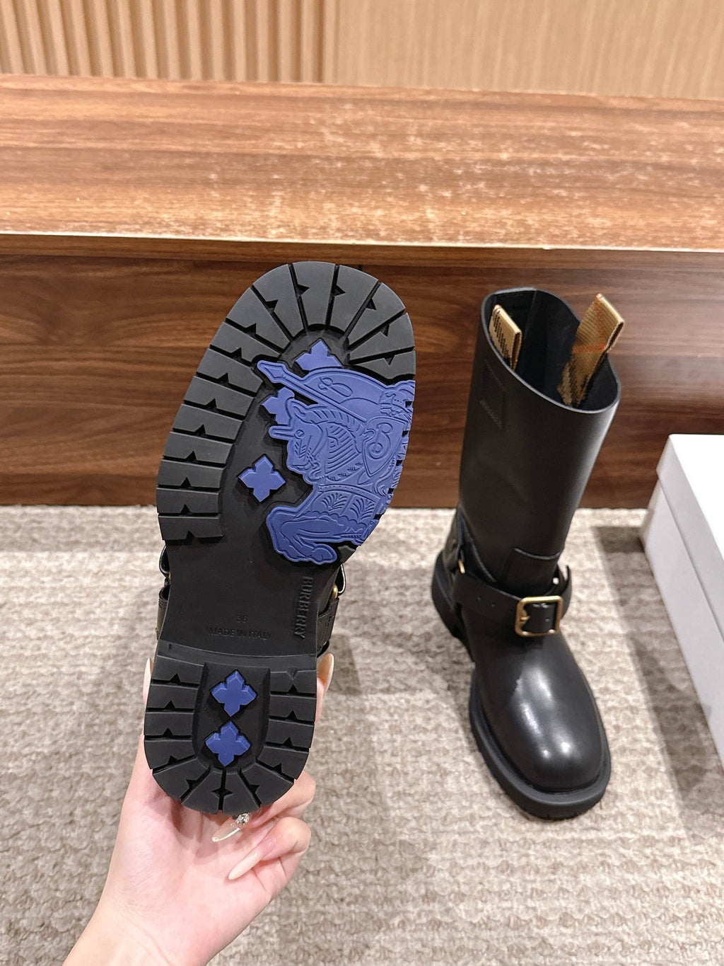 Boot outsole tread with blue patterned grip, beside a black mid-calf boot.