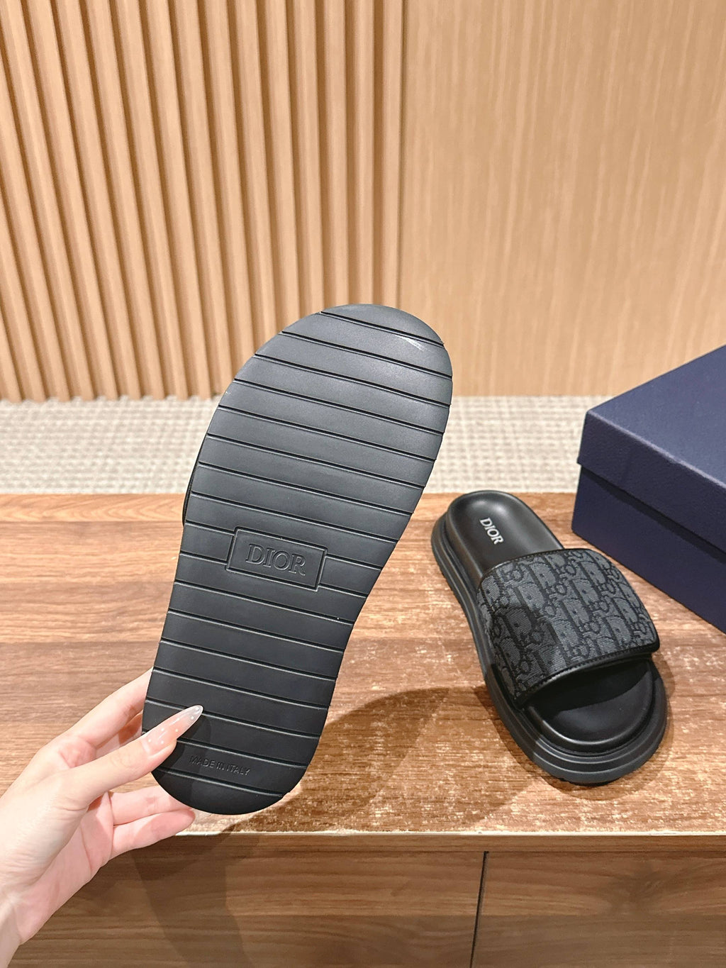Dior slide sandals outsole view with ridged black tread and footbed