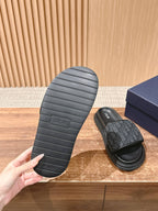 Dior slide sandals outsole view with ridged black tread and footbed