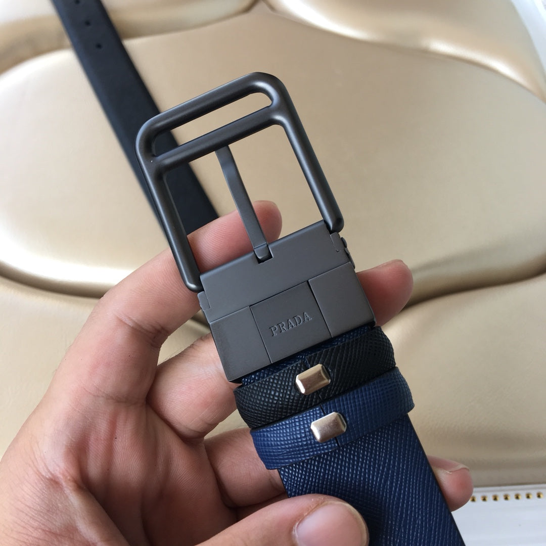Prada belt close-up with metal buckle and dark navy webbing keeper tabs