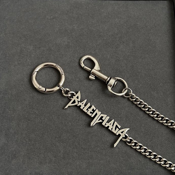 Silver-tone ring keychain and logo charm on dark gray pouch