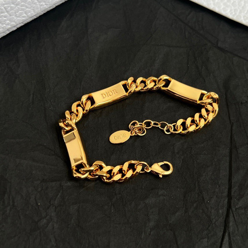 Gold-tone chain bracelet with engraved bar and clasp, with matching bracelet