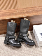 Black mid-calf boots with double front straps and gold-tone buckles, side view.