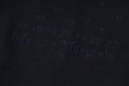 Dark navy fabric with embossed Maison Margiela Paris logo lettering