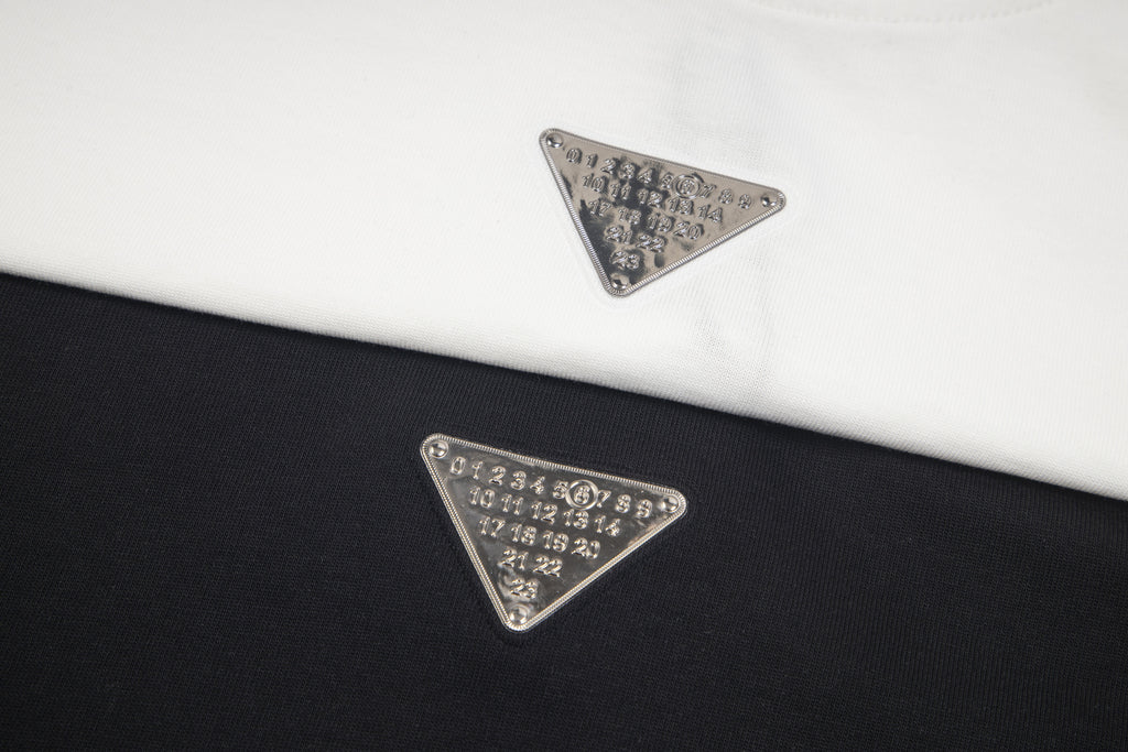 Maison Margiela embroidered triangular logo on T-shirt fabric