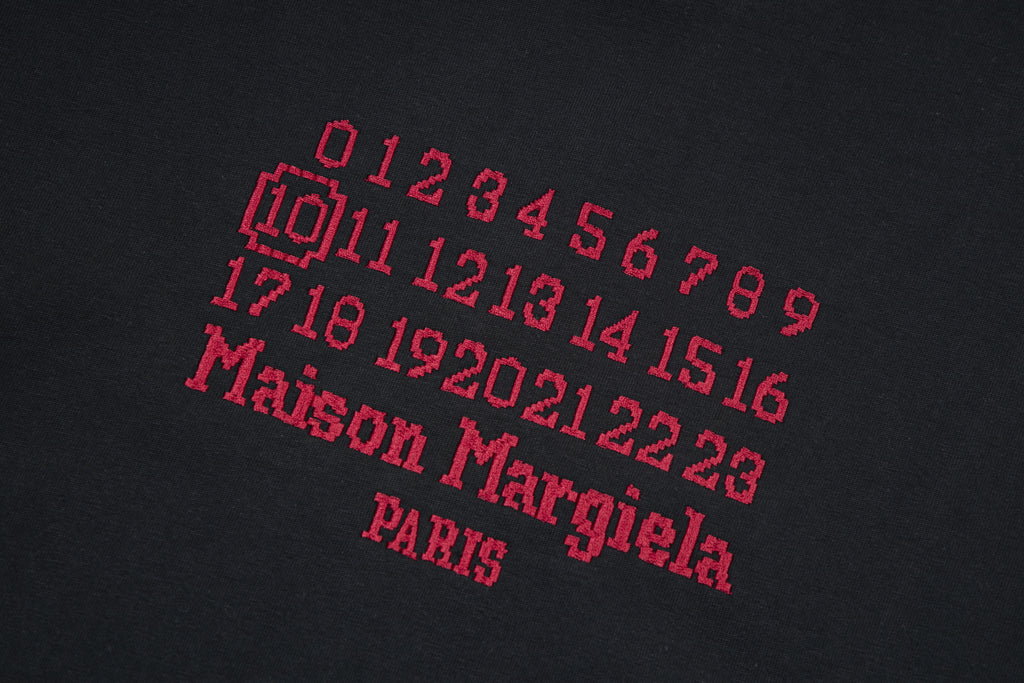 Black T-shirt with red and gray graphic numbers and text