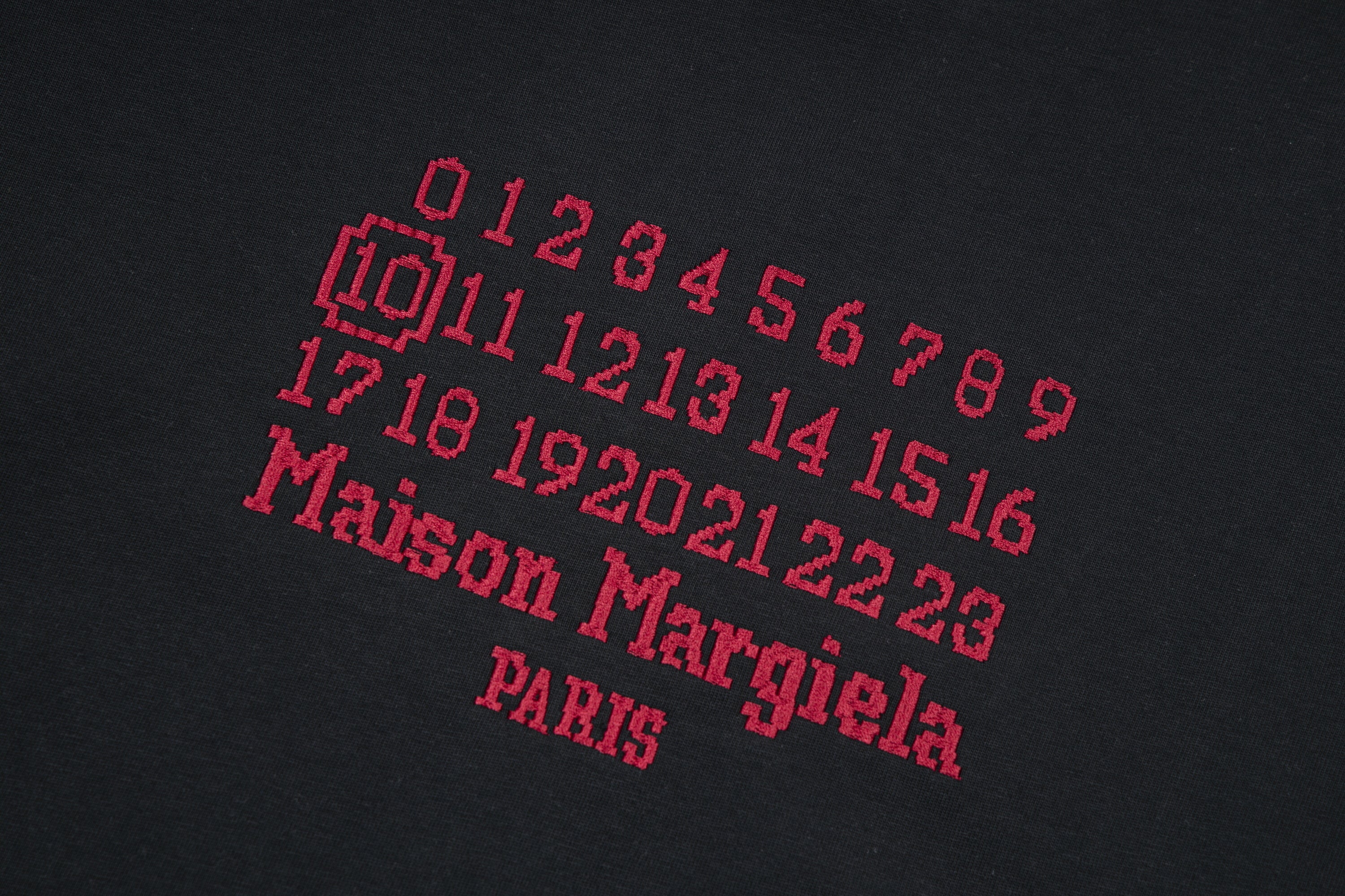 Black T-shirt with red and gray graphic numbers and text