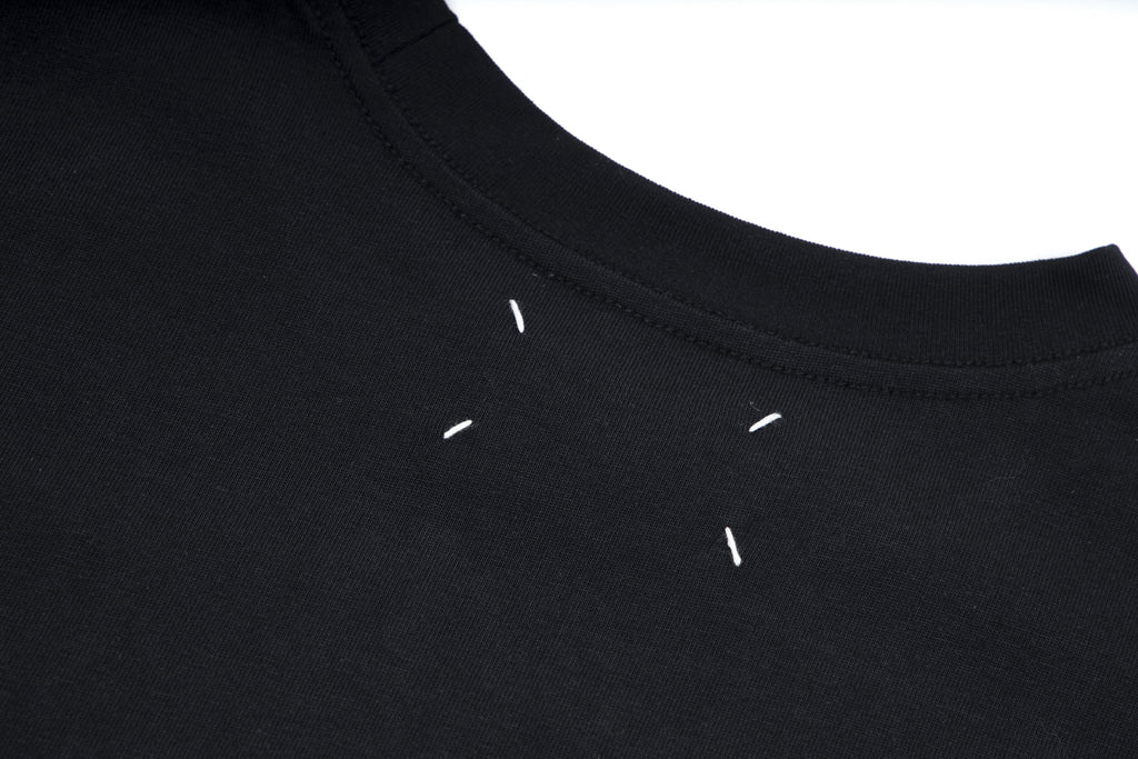 Black T-shirt crew neckline and shoulder seam detail
