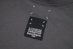 Black T-shirt neckline label with printed number graphic and Maison Margiela Paris text