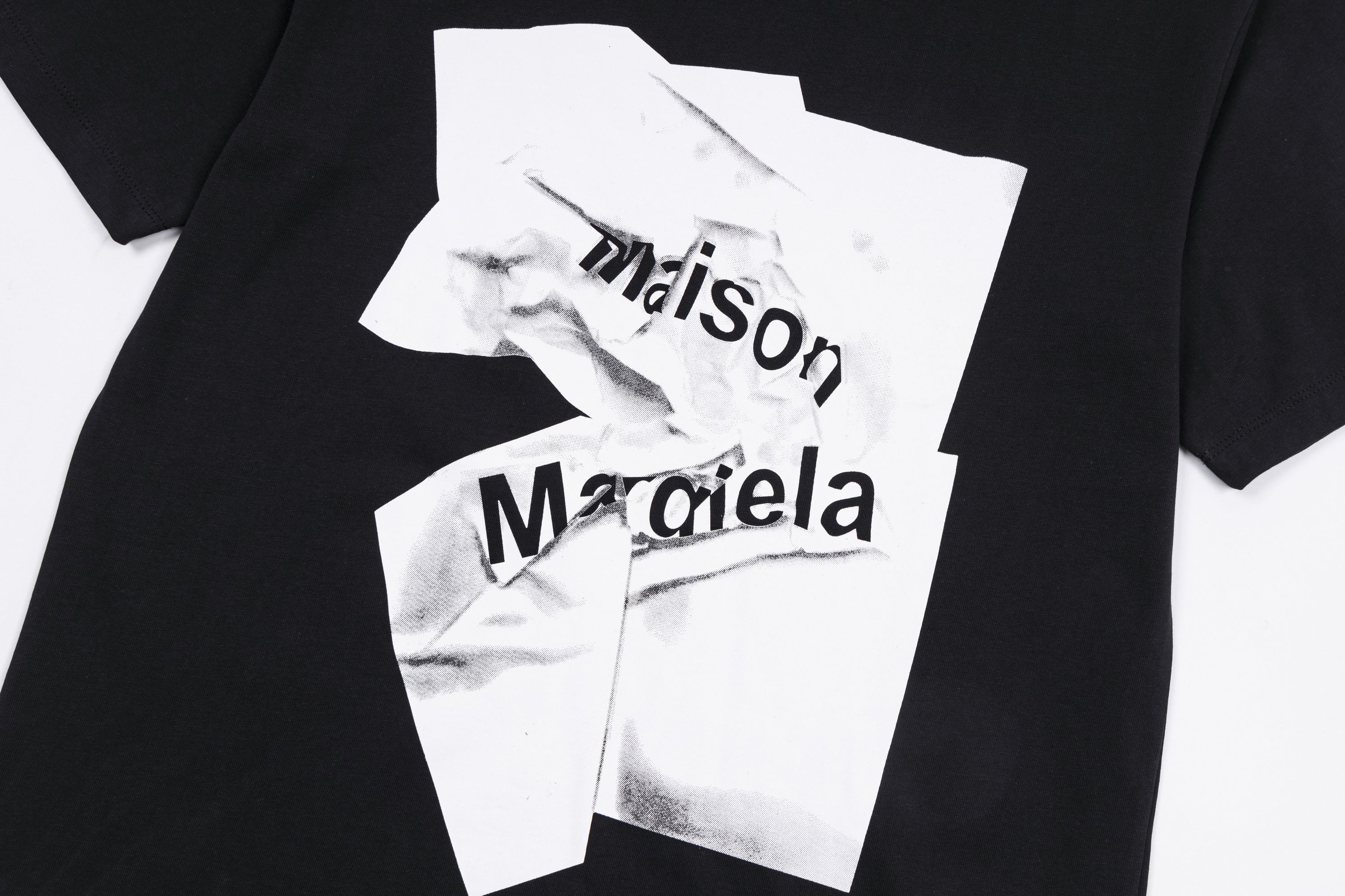 Maison Margiela black T-shirt close-up with white layered logo print